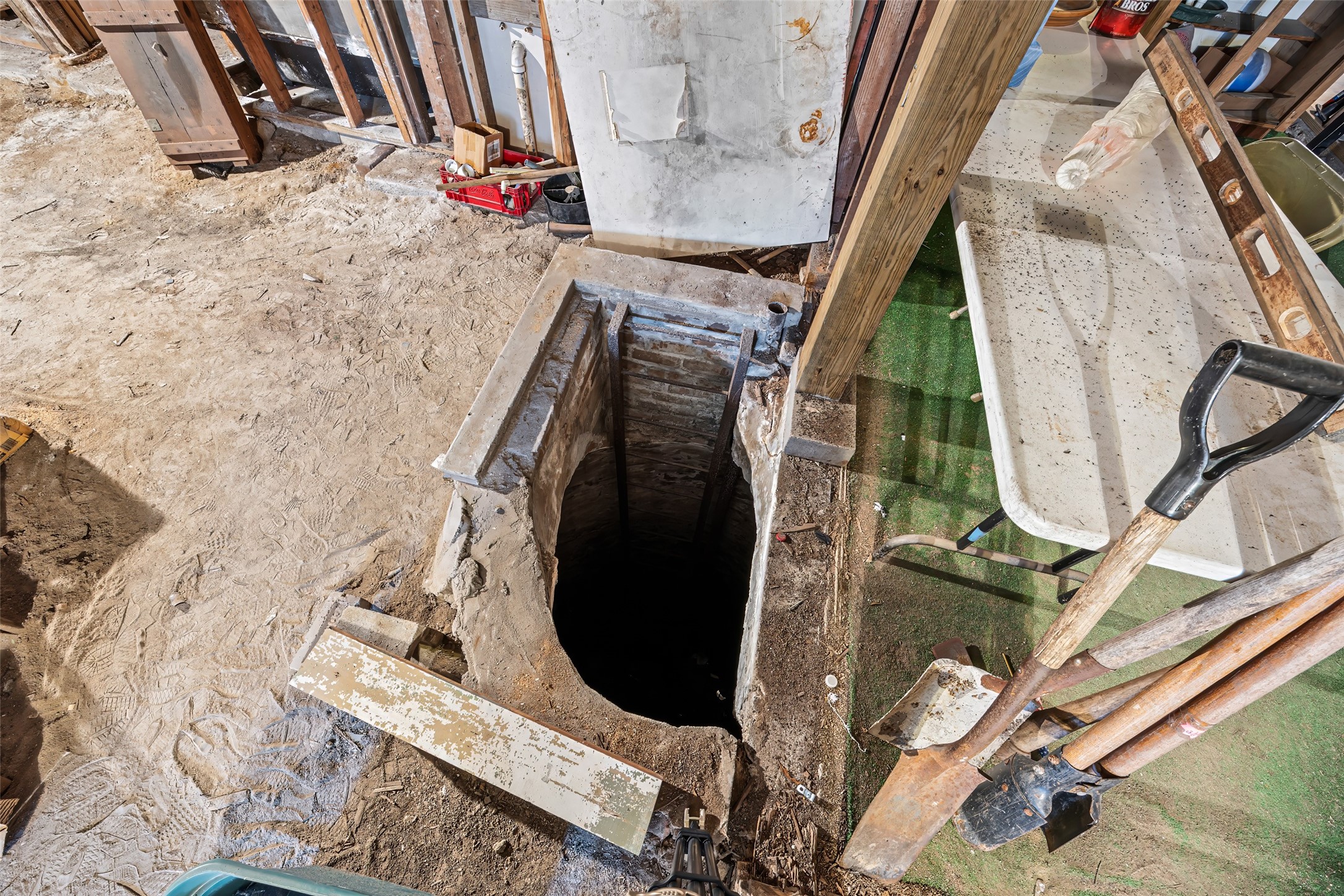 1214 Edwards Street Houston, TX 77007 - Photo 28 of 34 Discover the unique charm of this home with a historic, though no longer in service, water well on the first level, adding character and a touch of nostalgia to your living space.