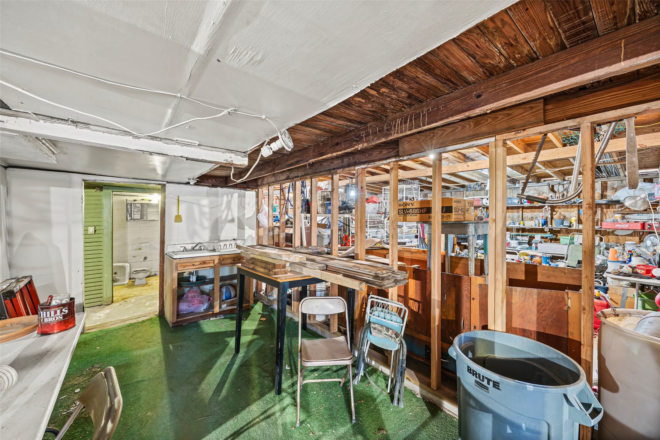 1214 Edwards Street Houston, TX 77007 - Photo 29 of 34 Discover your creative haven in this versatile workshop, featuring ample space, rustic charm, and practical amenities perfect for any project.