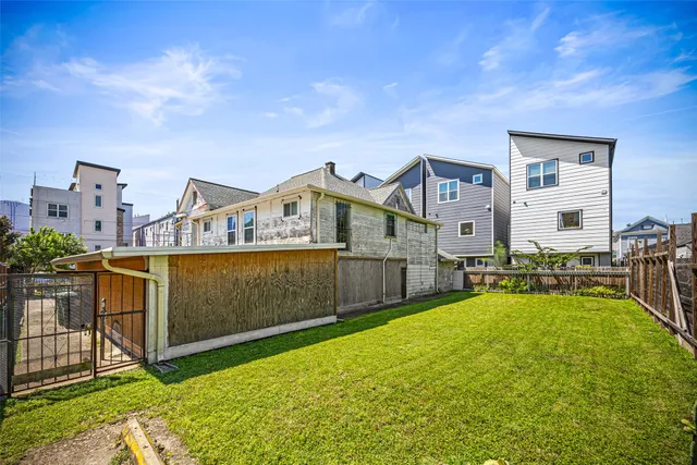 a view of a house with a big yard and large trees