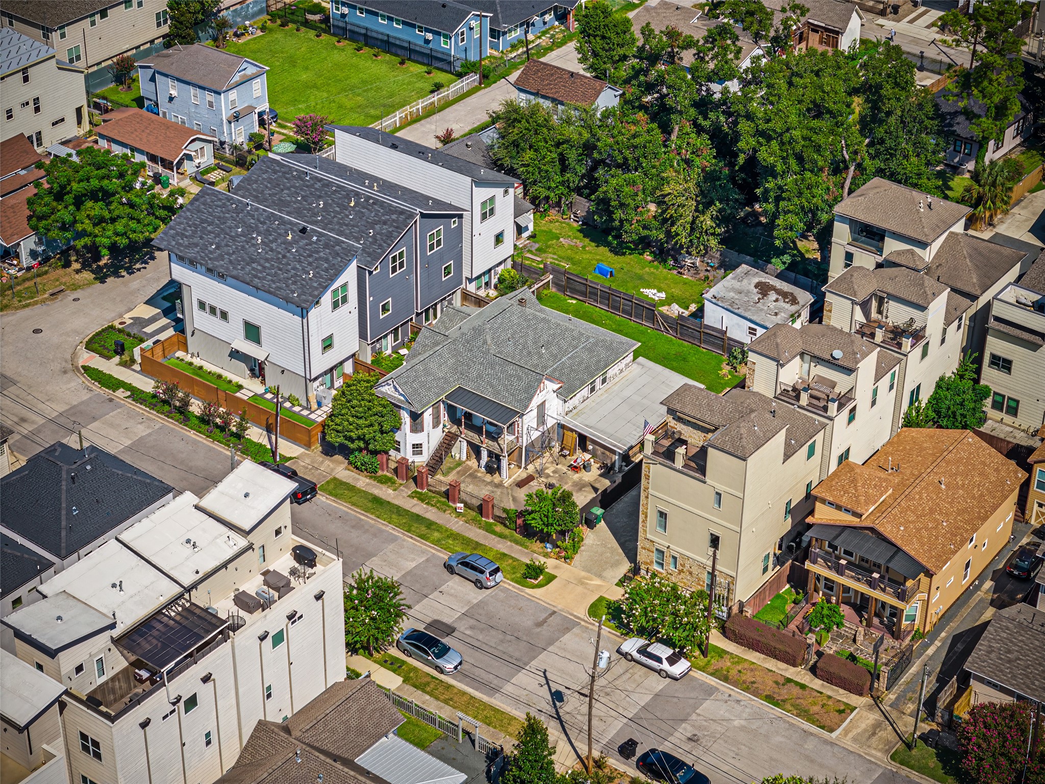 1214 Edwards Street Houston, TX 77007 - Photo 34 of 34 This aerial view showcases a diverse residential neighborhood with a mix of modern and traditional homes. It features tree-lined streets, ample parking, and a blend of multi-story and single-story houses, offering a sense of community and variety in architectural styles.