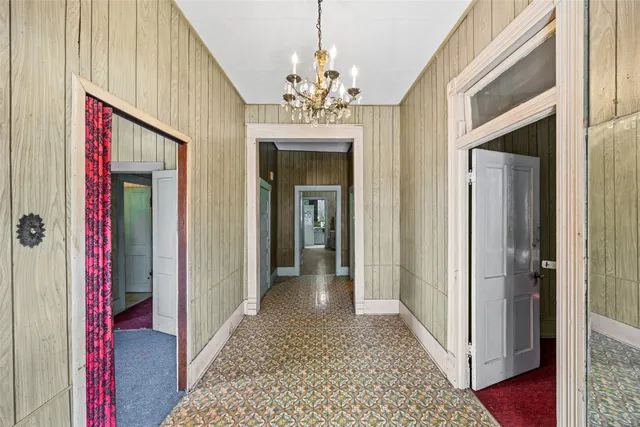 a bedroom with a bed and a chandelier