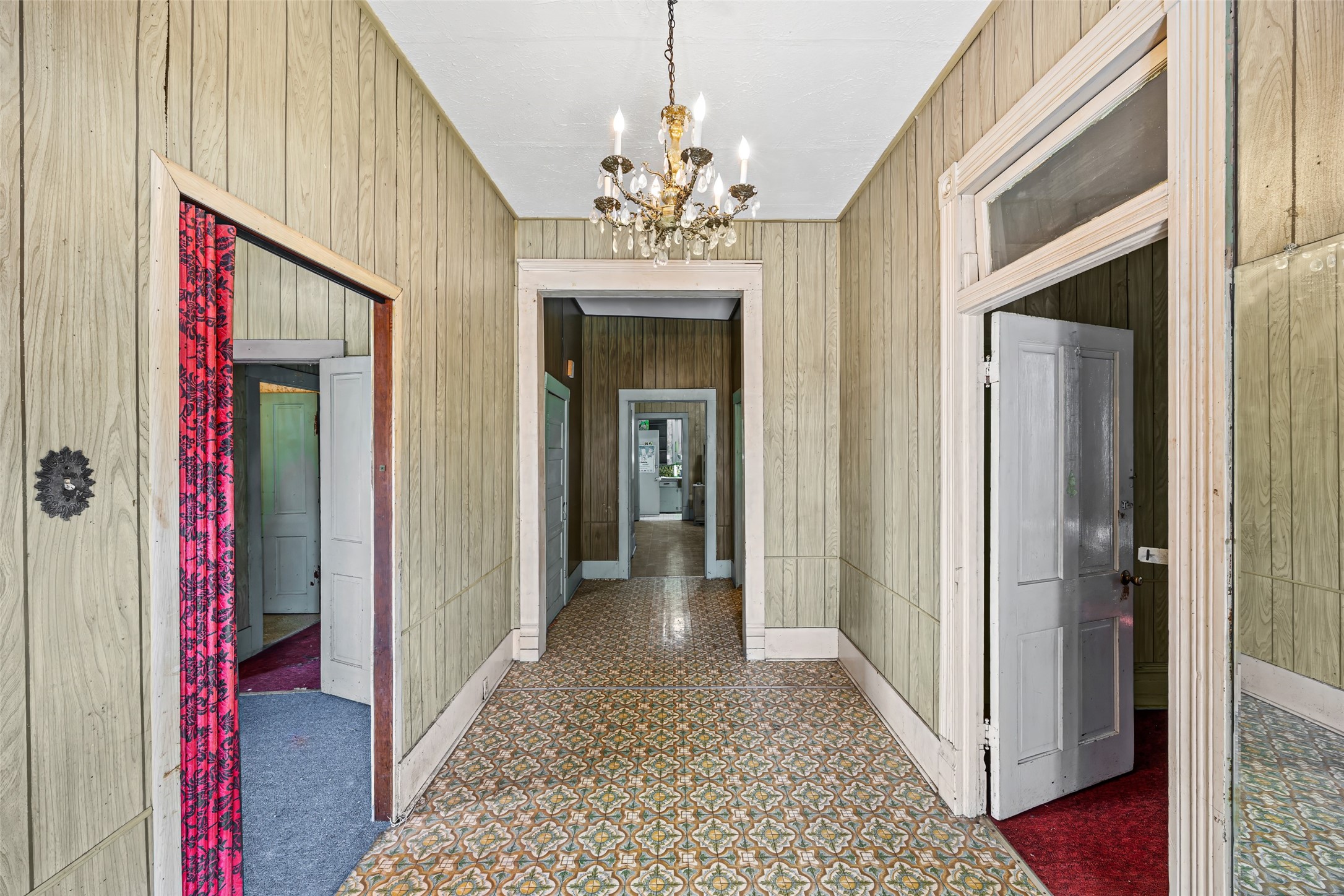 1214 Edwards Street Houston, TX 77007 - Photo 9 of 34 This inviting space boasts high ceilings and a stunning chandelier, offering a touch of elegance and grandeur.