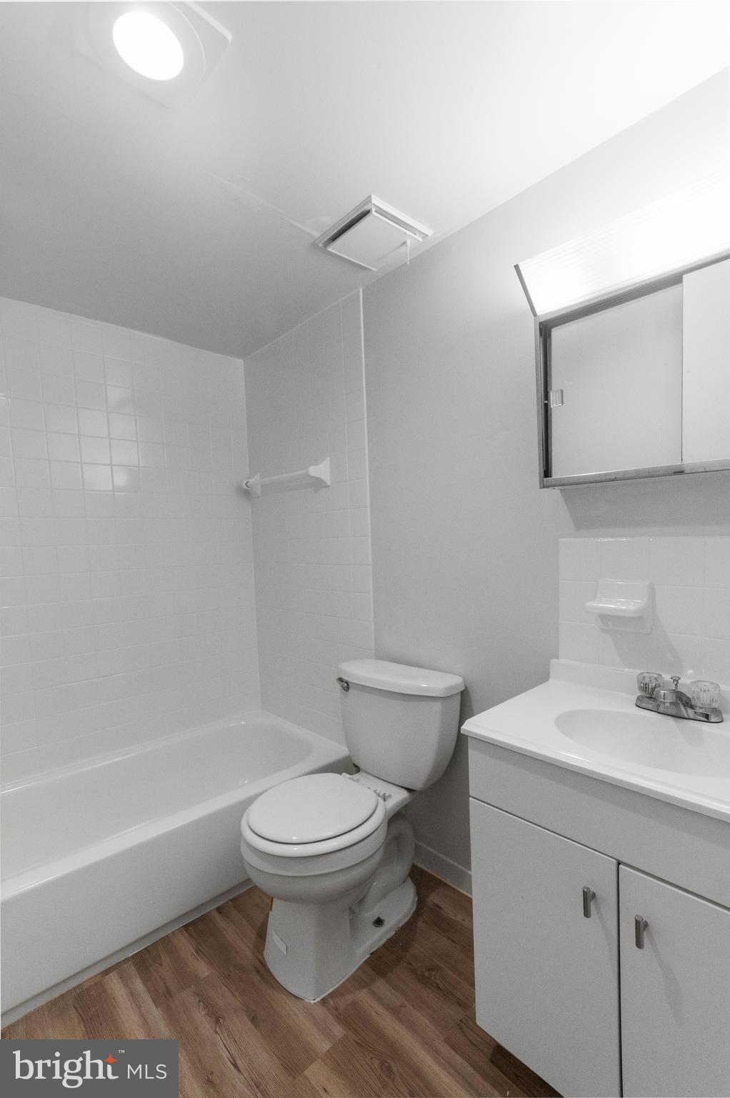 8030 Ditman Street, Unit 40G Philadelphia, PA 19136 - Photo 11 of 16 a white toilet sitting next to a bath tub