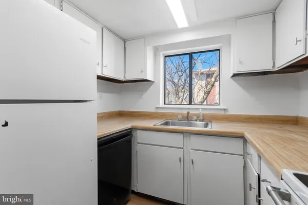 a kitchen with a sink cabinets and window