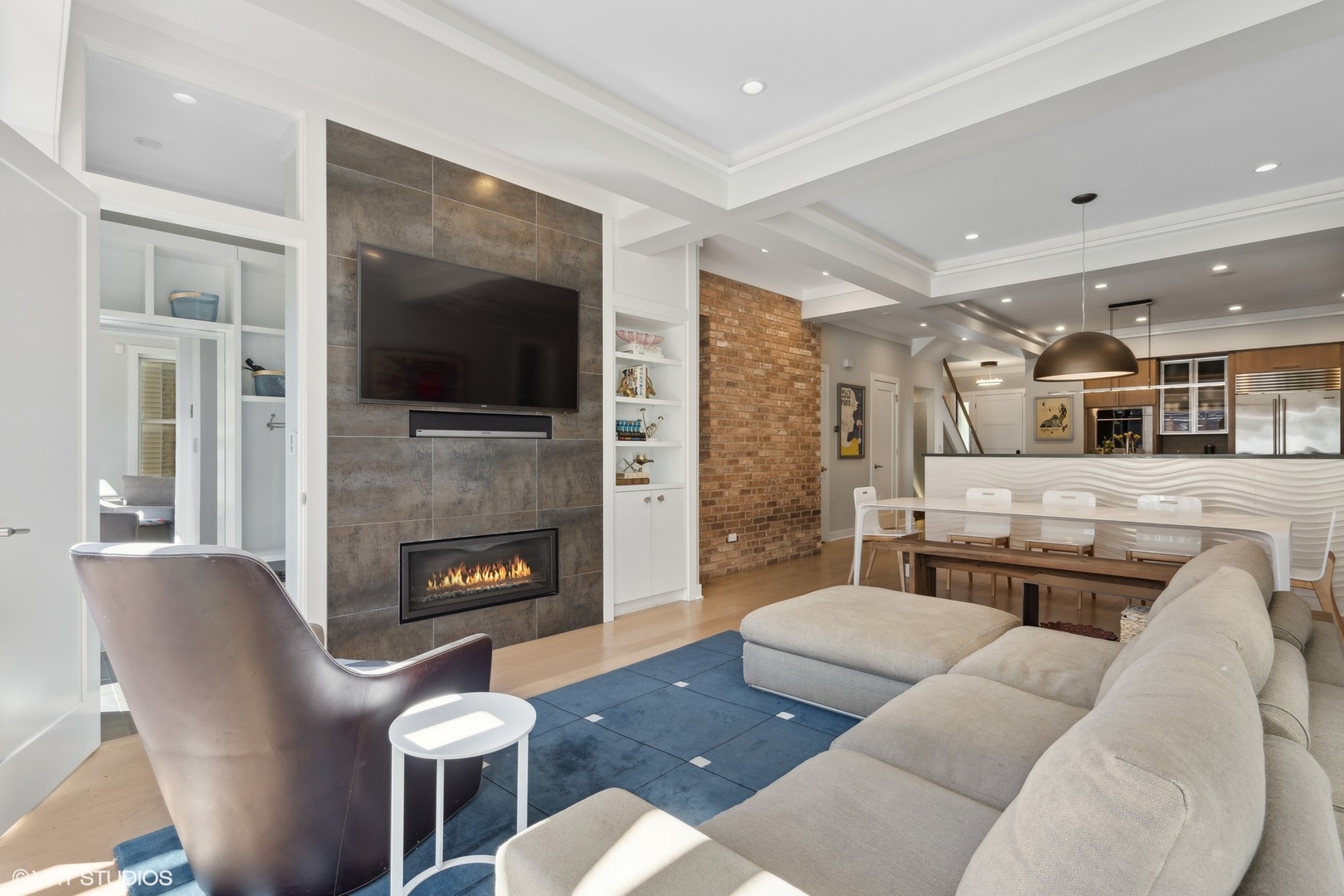 1925 West Grace Street Chicago, IL 60613 - Photo 15 of 45 a living room with furniture a flat screen tv and a fireplace
