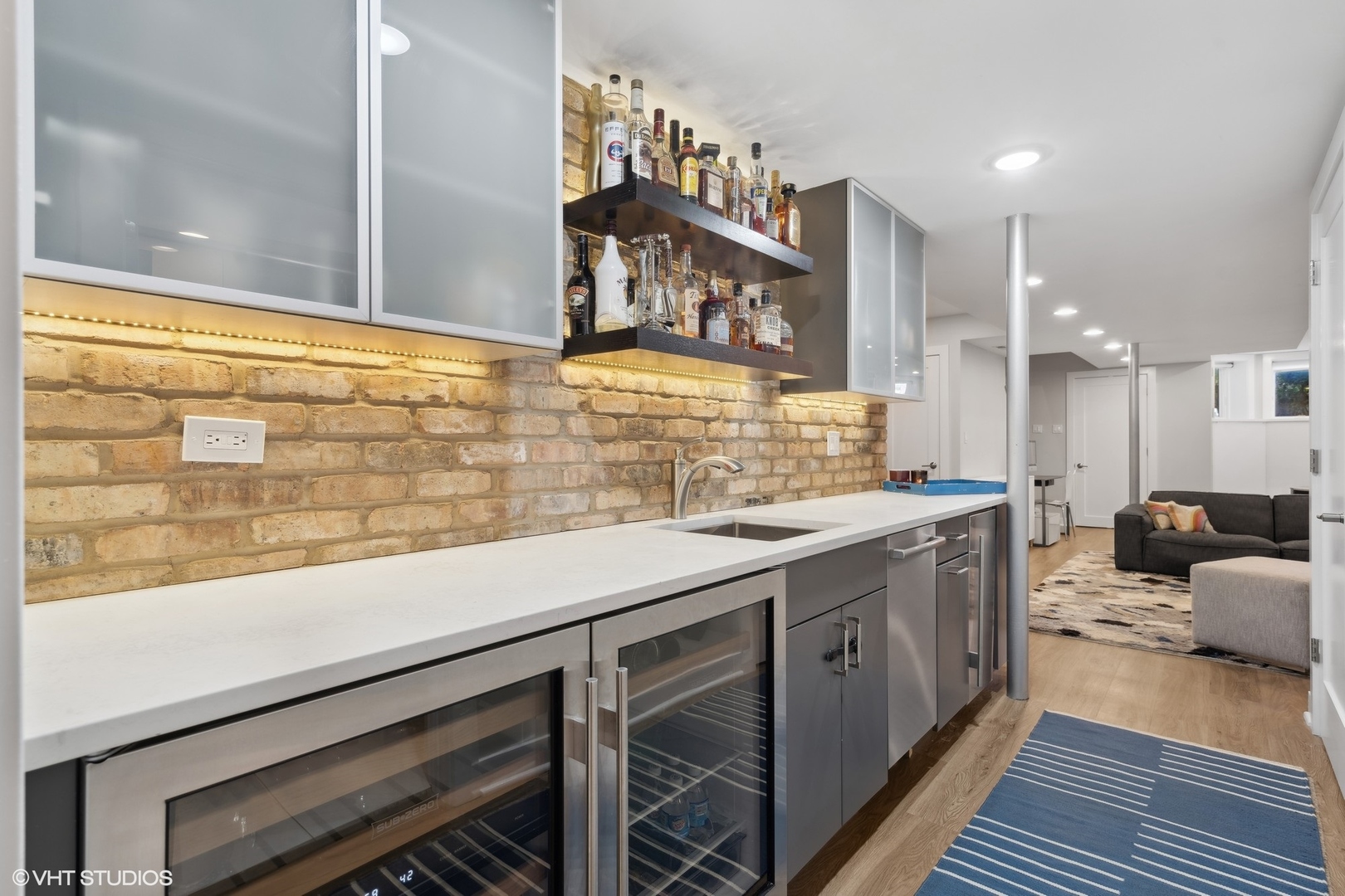 1925 West Grace Street Chicago, IL 60613 - Photo 33 of 45 a kitchen with stainless steel appliances kitchen island granite countertop a sink and cabinets