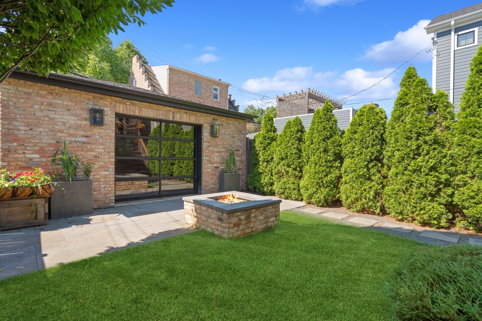 1925 West Grace Street Chicago, IL 60613 - Photo 41 of 45 a backyard of a house with a fountain table and chairs