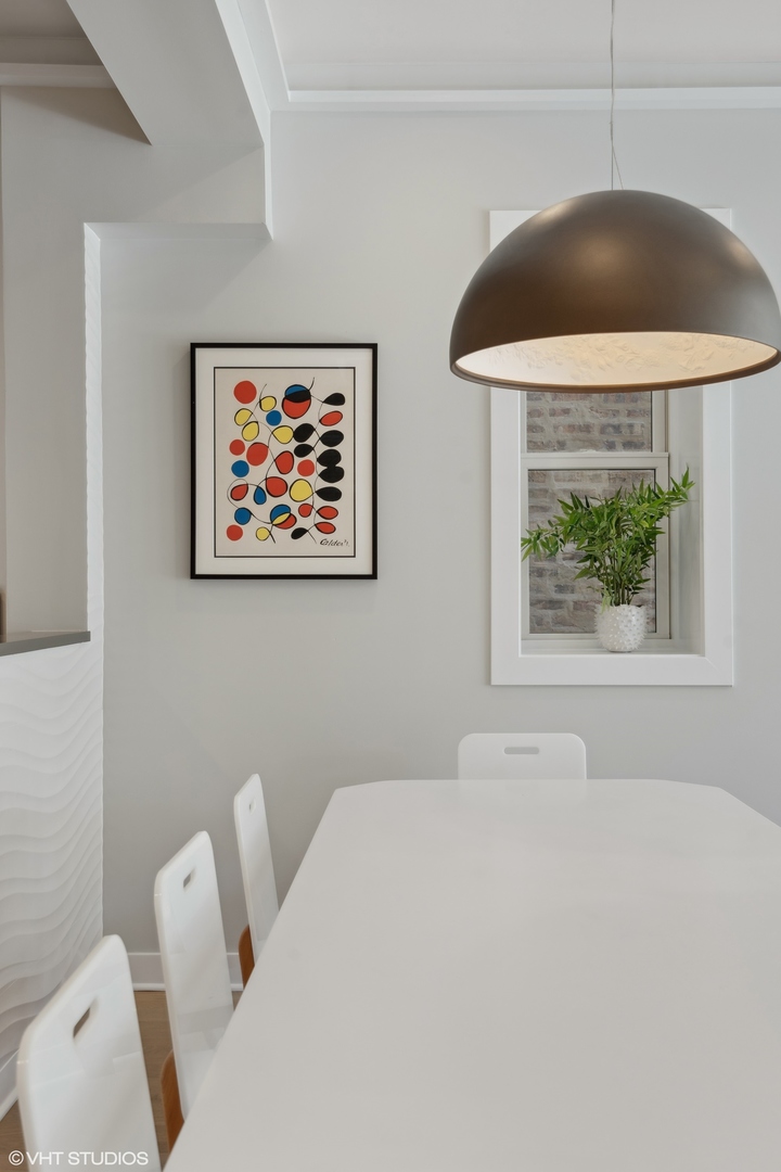 1925 West Grace Street Chicago, IL 60613 - Photo 10 of 45 a living room with a couch and a painting on the wall