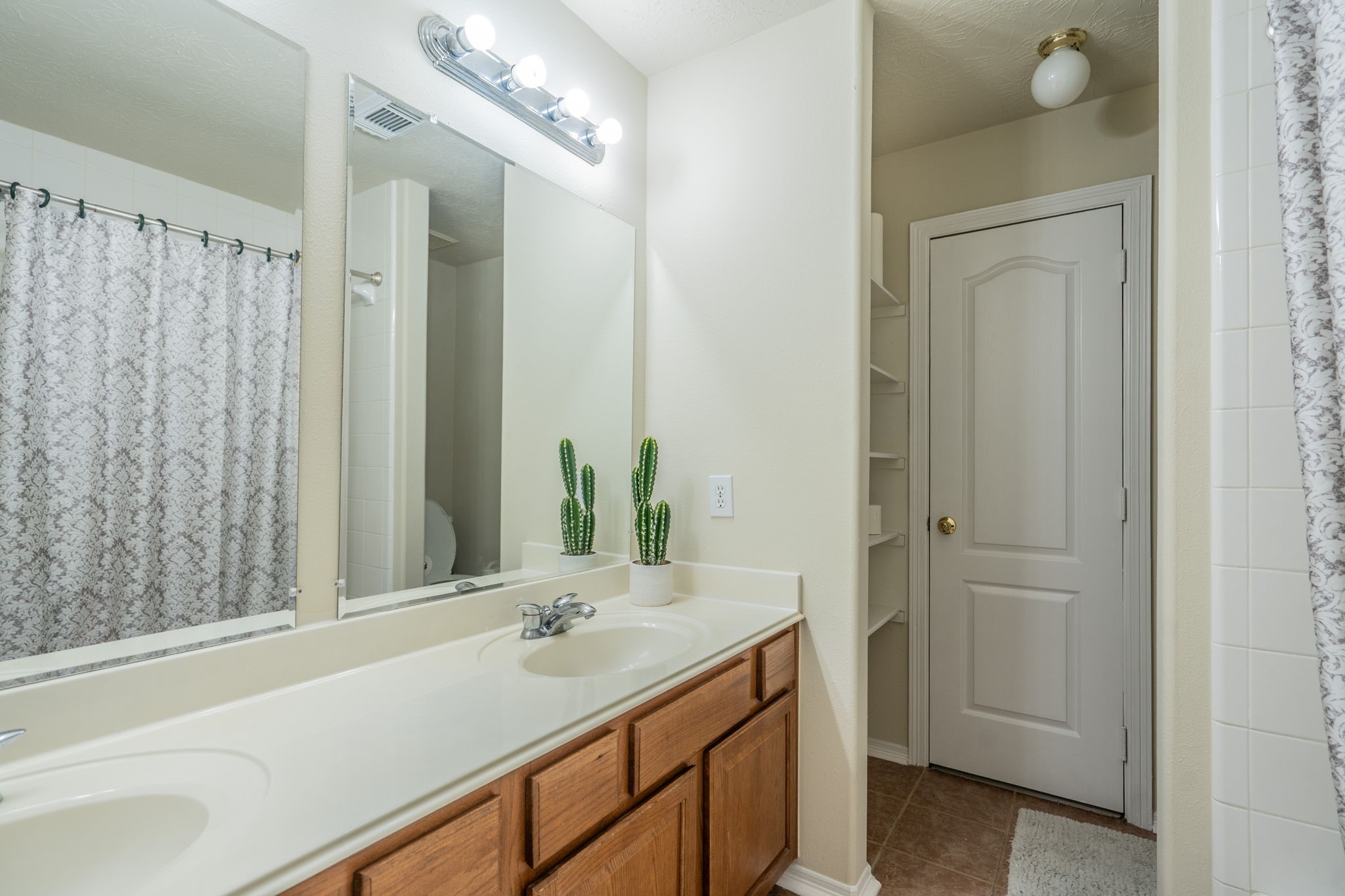 24139 Spring Sunset Drive Spring, TX 77373 - Photo 19 of 26 a bathroom with a sink and a mirror