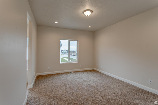 1512 West 600 North, Unit O4A Mapleton, UT 84664 - Photo 10 of 24 Spare room featuring light carpet, a textured ceiling, and recessed lighting