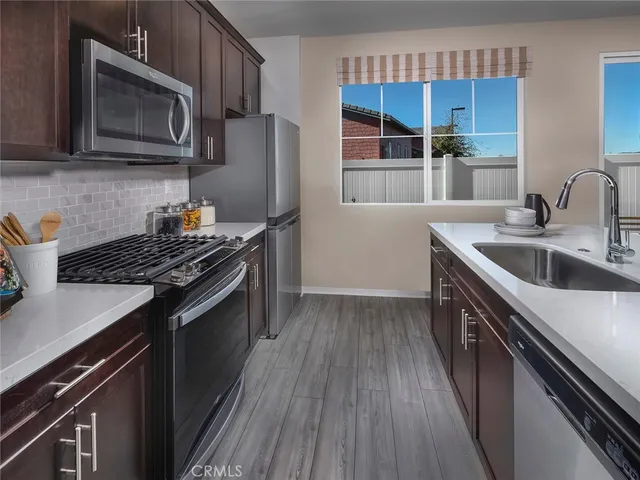 a kitchen with stainless steel appliances a sink dishwasher stove and microwave