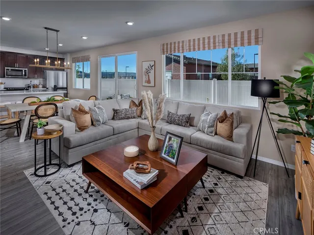 a living room with furniture a rug and a large window