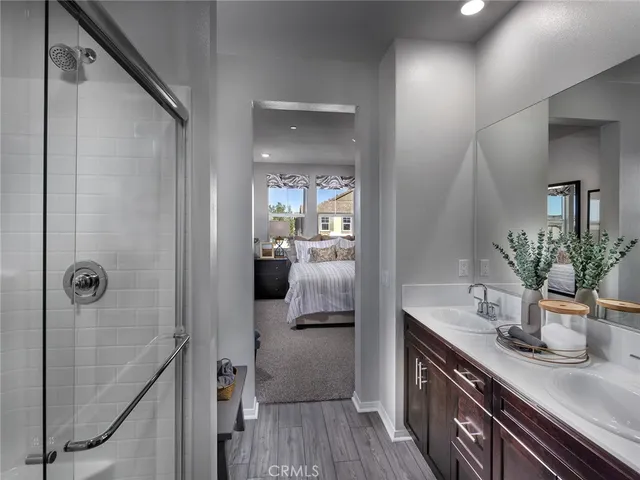 a bathroom with a sink a mirror and shower
