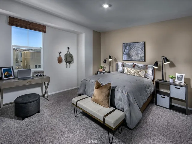 a bedroom with a bed and a couch