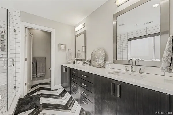 a bathroom with a double vanity sink and a mirror