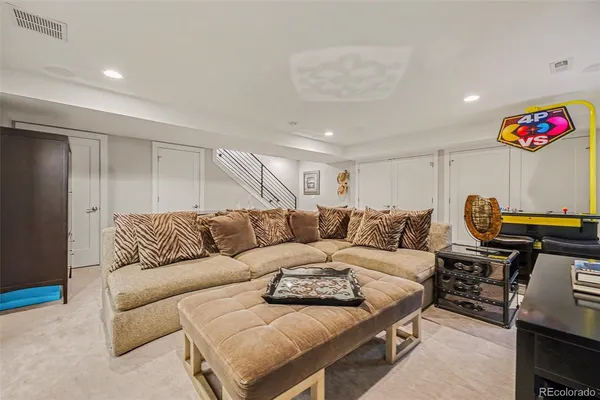 a living room with furniture and a potted plant