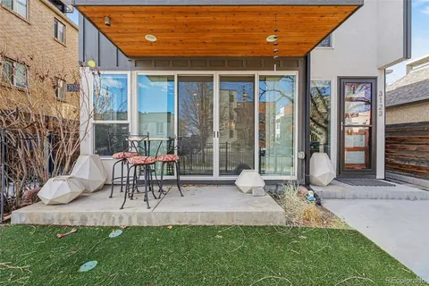 a view of a patio with table and chairs and potted plants