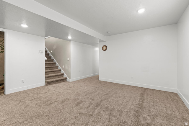 463 South Trejo Ridge Road Grantsville, UT 84029 - Photo 17 of 22 Spacious room featuring neutral carpeting, white painted walls, and recessed lighting