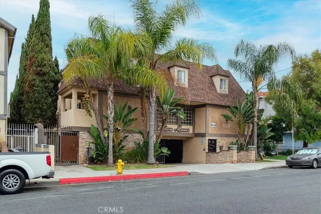 a view of a kitchen with wooden floor a sink and a window