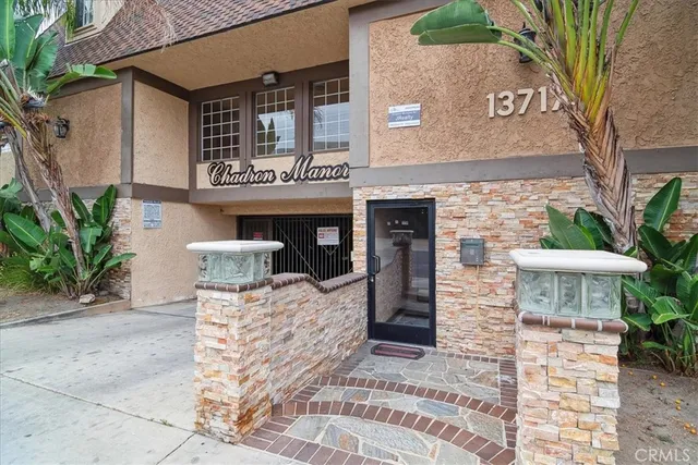 a front view of a building with potted plants