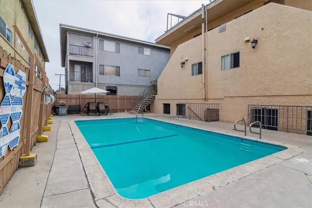 a view of a house with pool and chairs