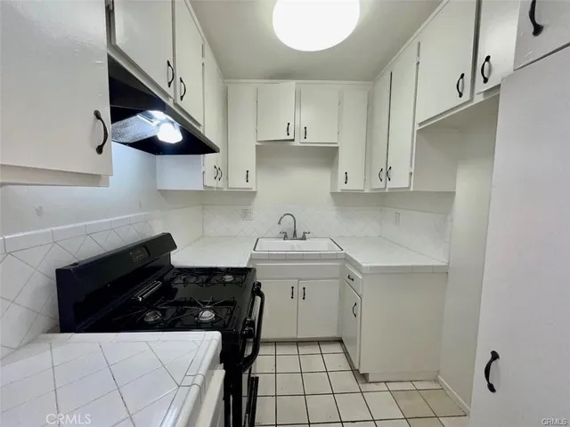 a view of wooden floor and cabinet in a room