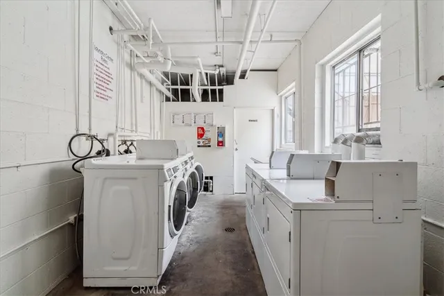 a utility room with cabinets washer and dryer