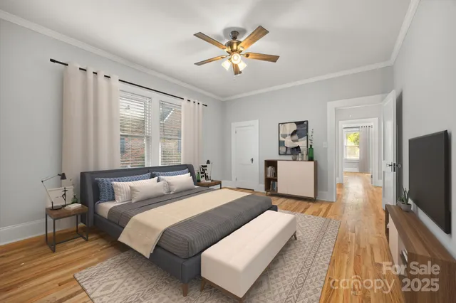 a bedroom with a large bed and a flat tv screen on dresser