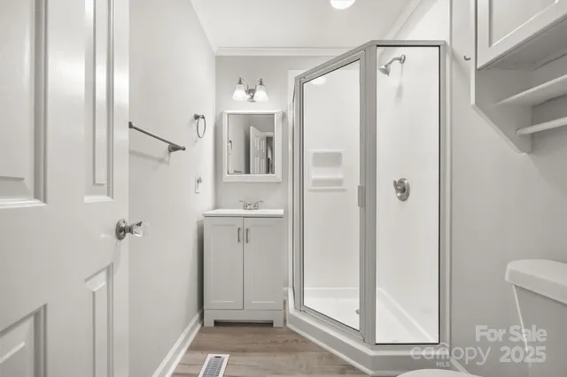 a bathroom with a shower and a sink