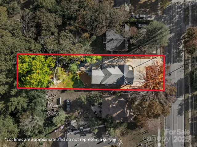 an aerial view of residential houses with outdoor space and trees