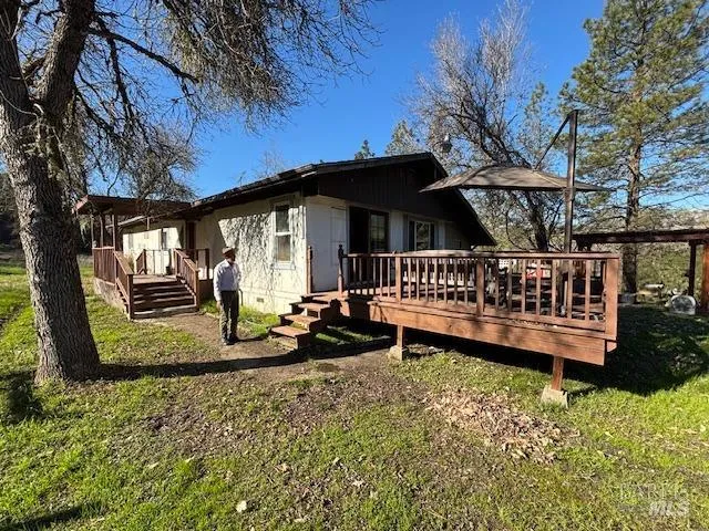 a view of a house with backyard and sitting area