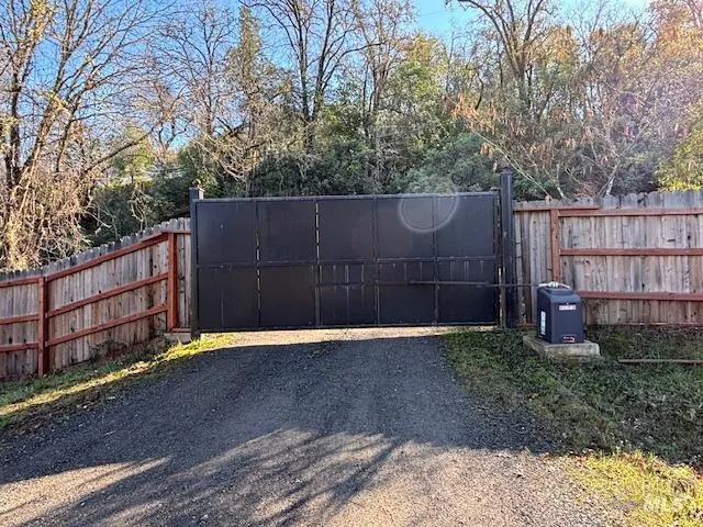 a view of backyard with wooden fence