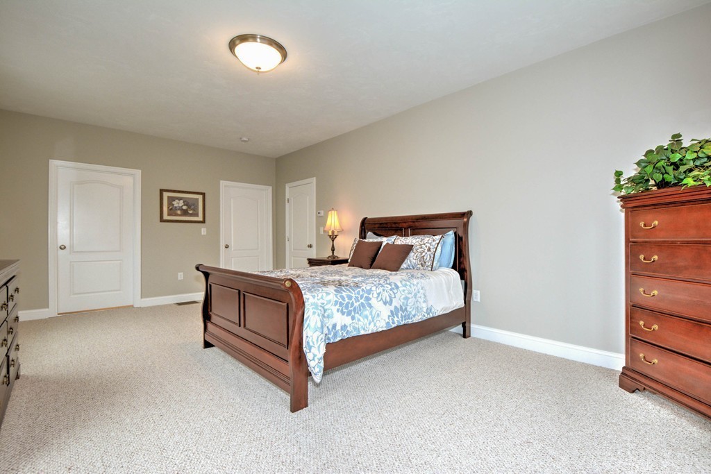 54 Partridge Hill Road Sutton, MA 01590 - Photo 13 of 20 a bedroom with a bed and a potted plant