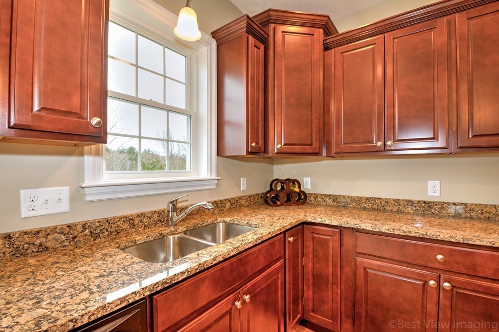 54 Partridge Hill Road Sutton, MA 01590 - Photo 6 of 20 a kitchen with stainless steel appliances granite countertop a sink and a window