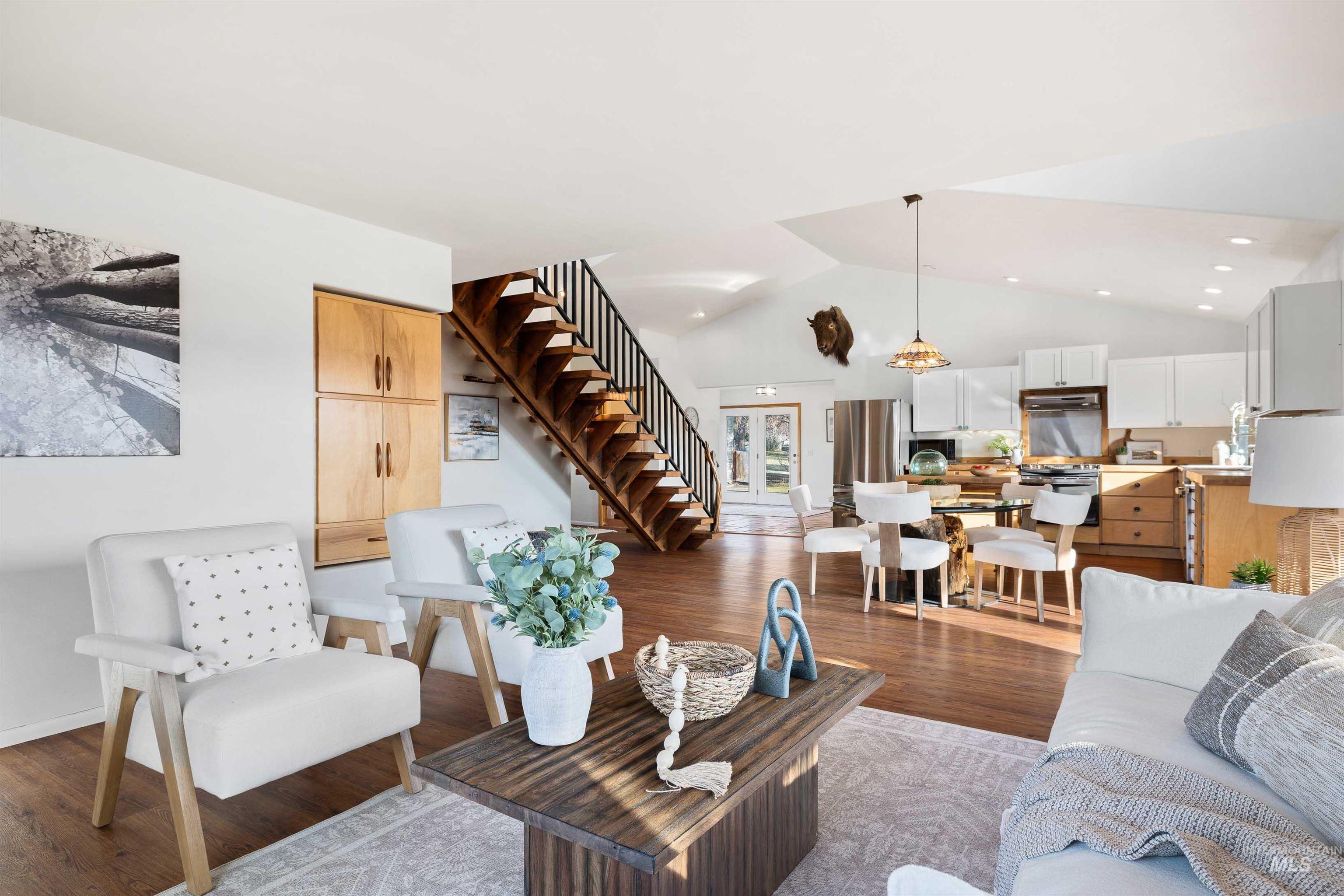 853 Pottery Road Bliss, ID 83314 - Photo 11 of 50 Living area featuring lofted ceiling, stairway, and light wood-style floors