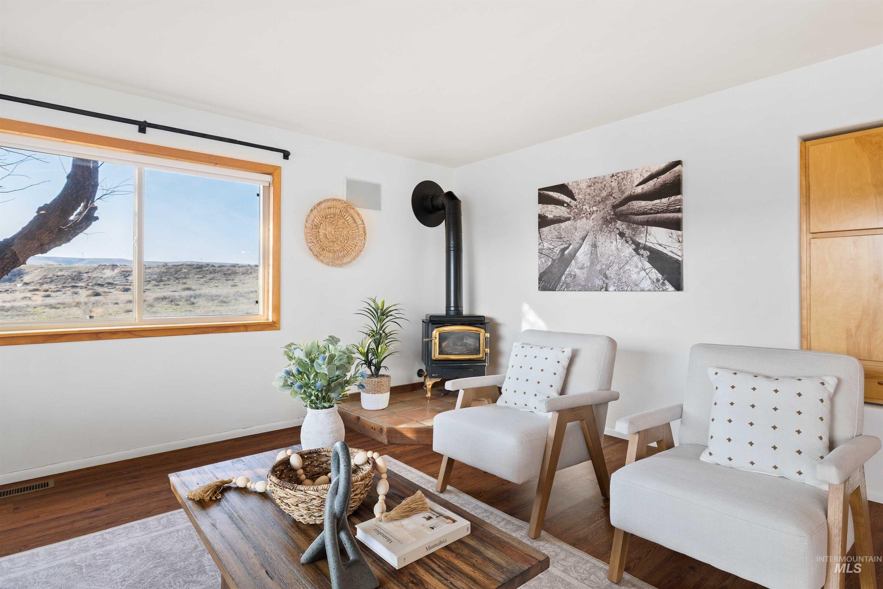 853 Pottery Road Bliss, ID 83314 - Photo 12 of 50 Sitting room featuring a wood stove and wood finished floors