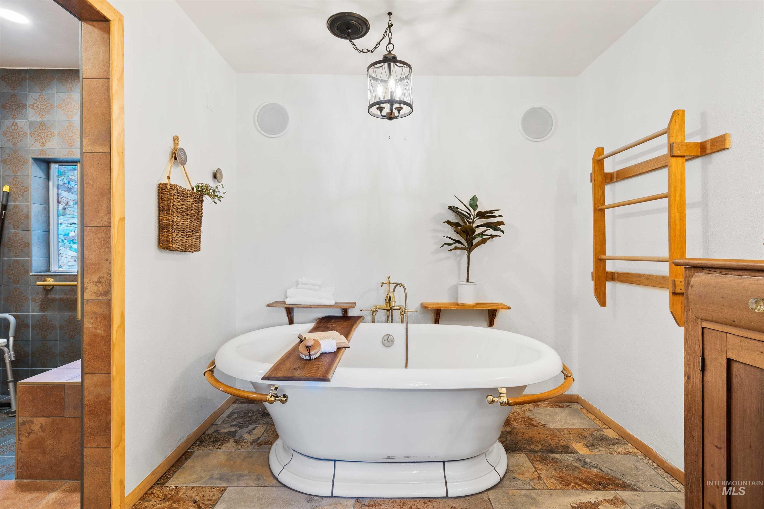 853 Pottery Road Bliss, ID 83314 - Photo 18 of 50 Full bath with stone tile floors and a freestanding tub