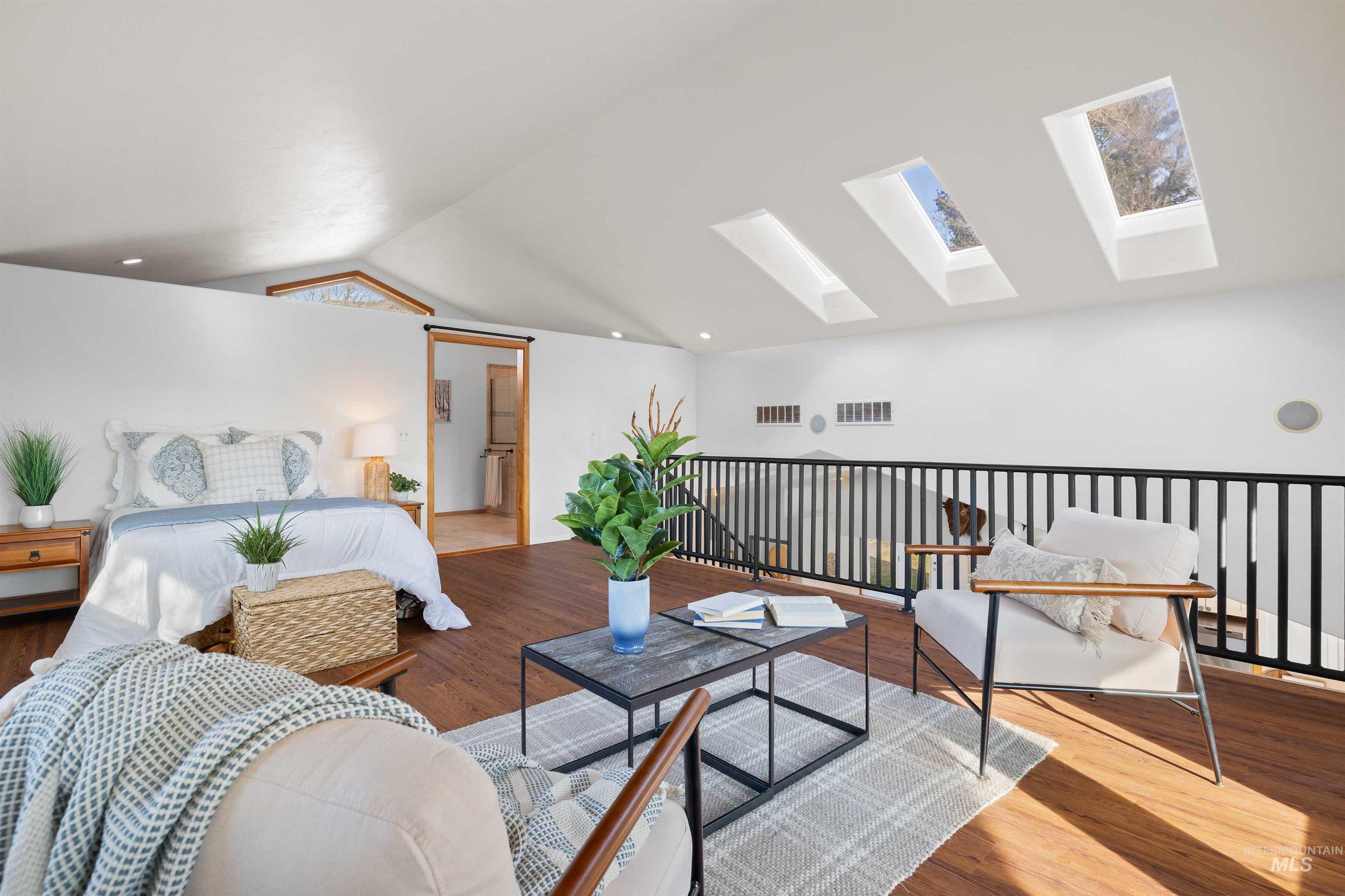 853 Pottery Road Bliss, ID 83314 - Photo 23 of 50 Bedroom featuring a skylight, wood finished floors, vaulted ceiling, and recessed lighting