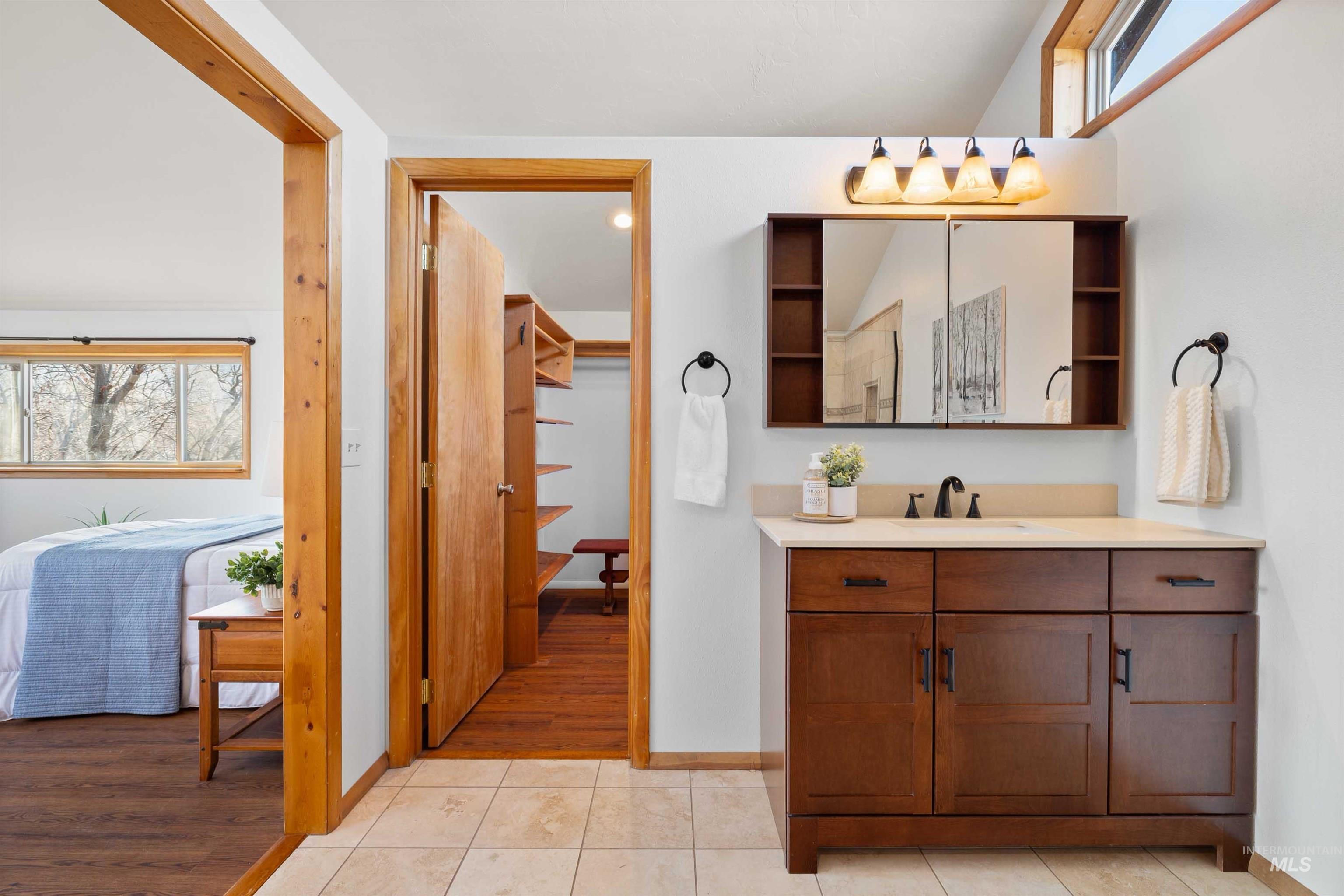 853 Pottery Road Bliss, ID 83314 - Photo 25 of 50 Ensuite bathroom featuring vanity, light tile patterned floors, recessed lighting, and lofted ceiling