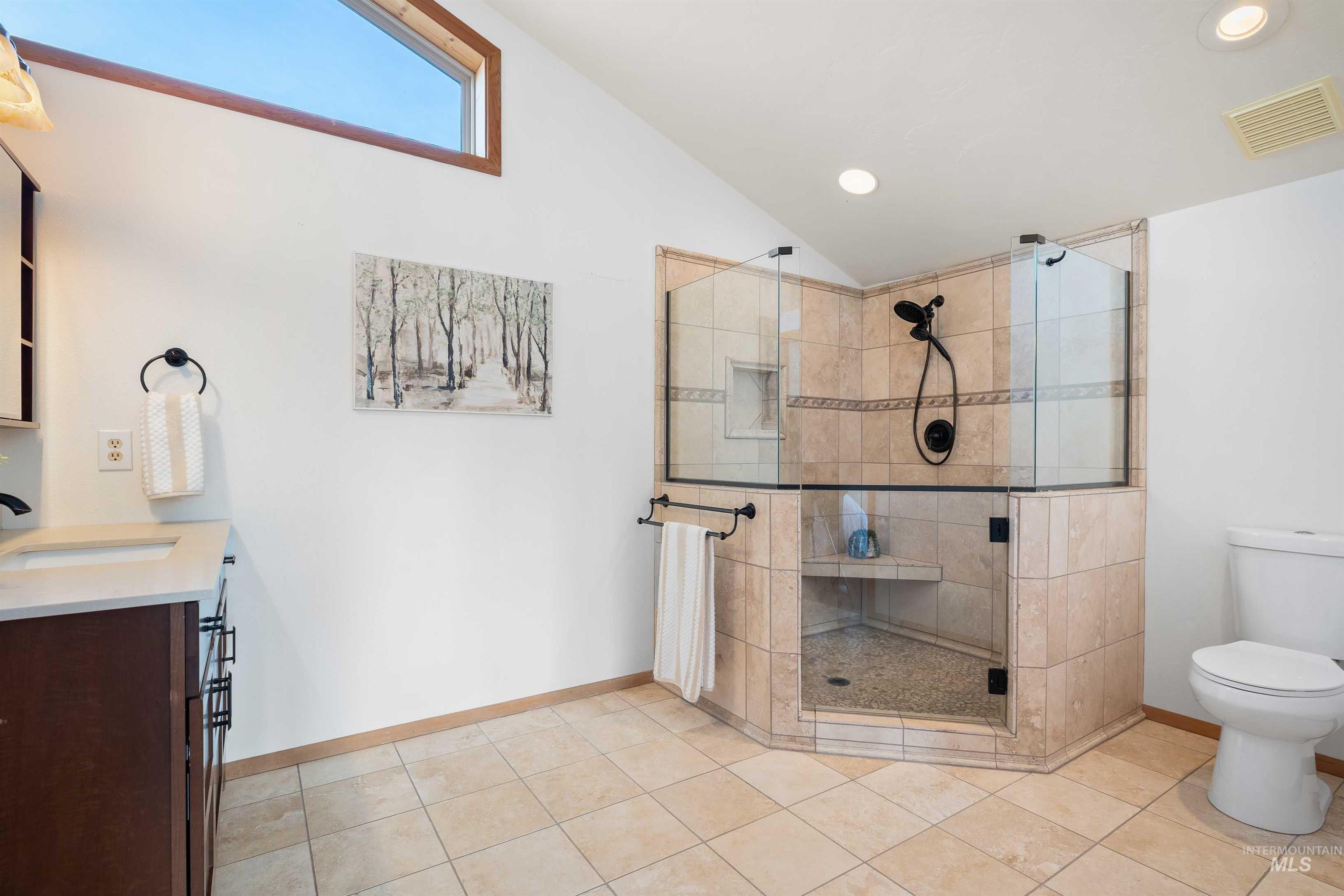 853 Pottery Road Bliss, ID 83314 - Photo 27 of 50 Full bath featuring vanity, lofted ceiling, a stall shower, recessed lighting, and light tile patterned floors