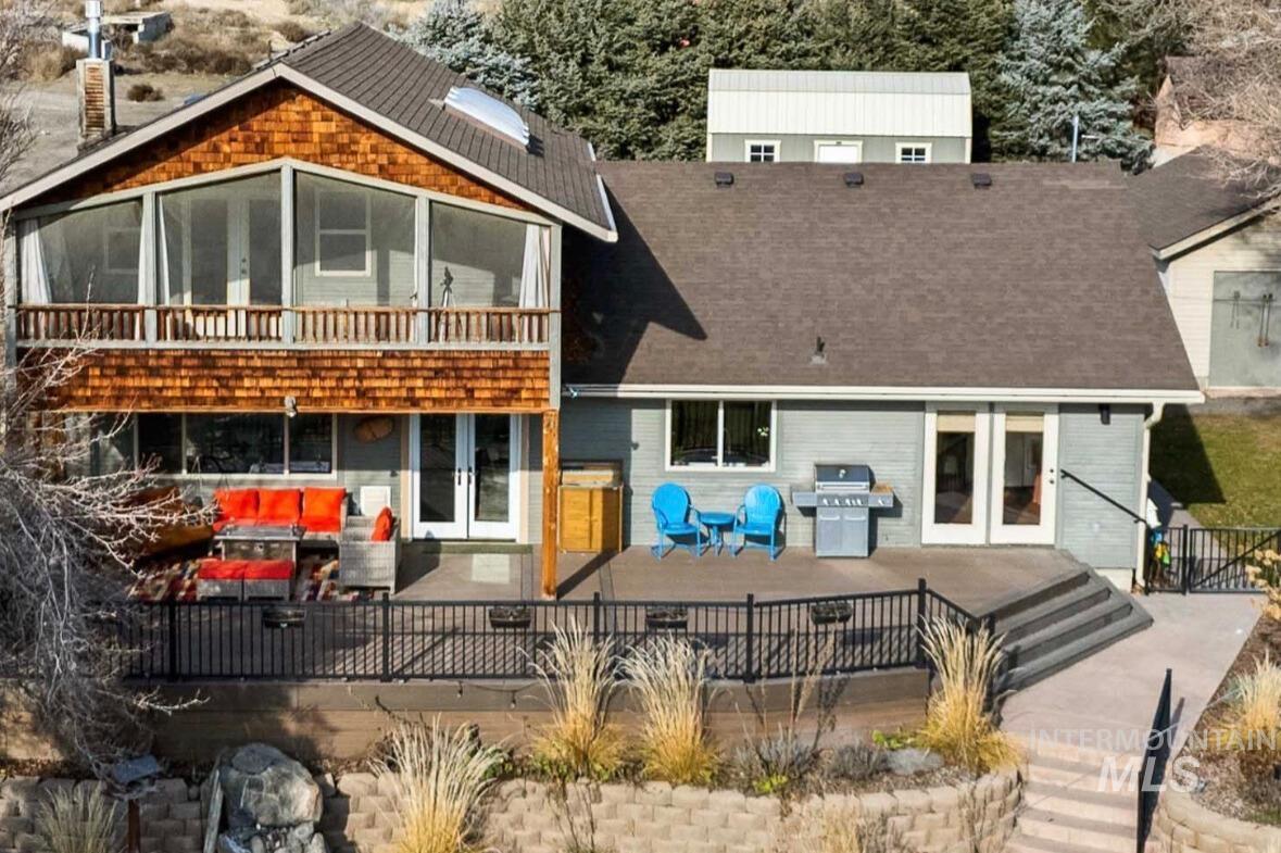 853 Pottery Road Bliss, ID 83314 - Photo 49 of 50 Rear view of property with a patio, french doors, a deck, a sunroom, and roof with shingles