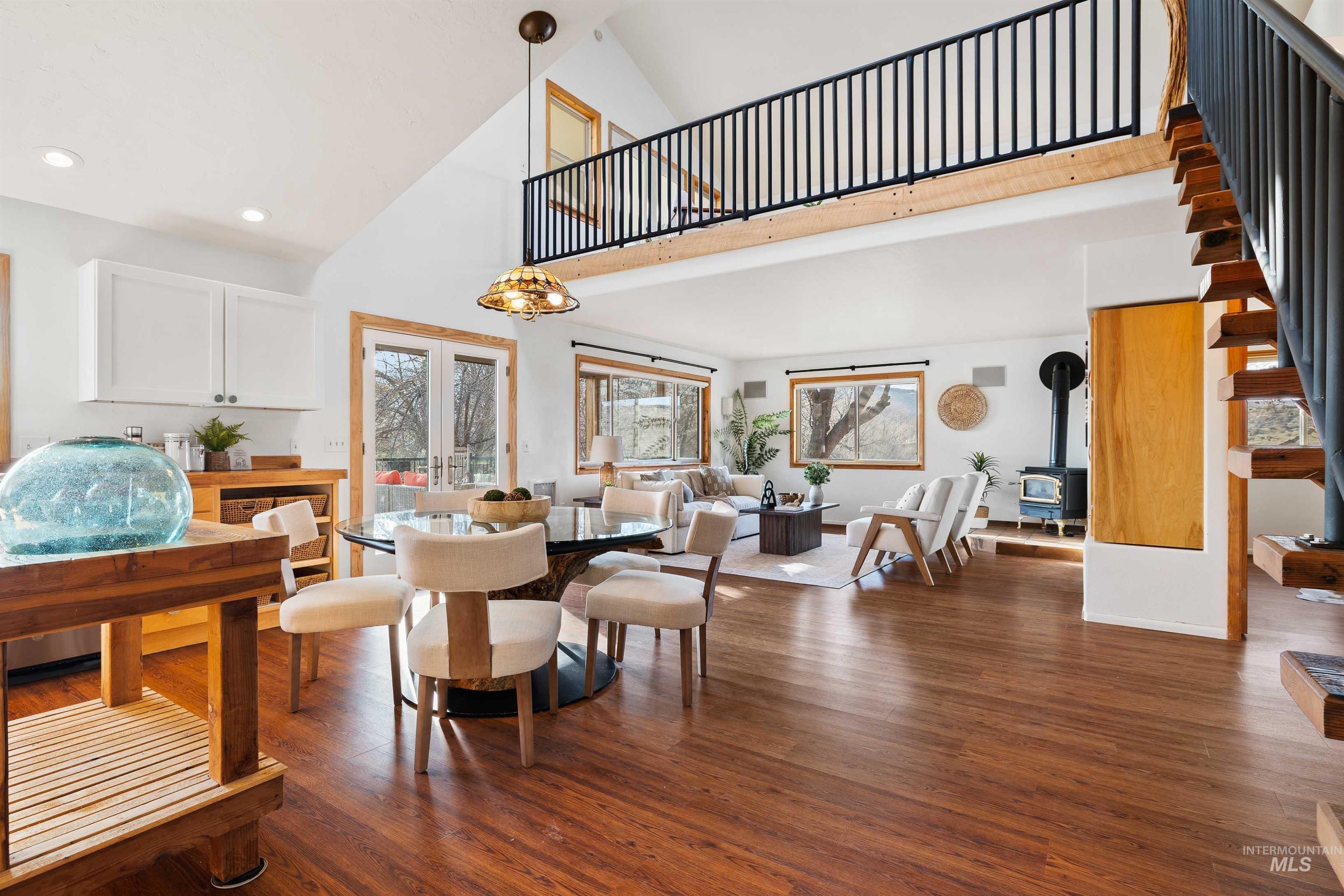853 Pottery Road Bliss, ID 83314 - Photo 7 of 50 Dining room featuring a wood stove, wood finished floors, high vaulted ceiling, french doors, and recessed lighting