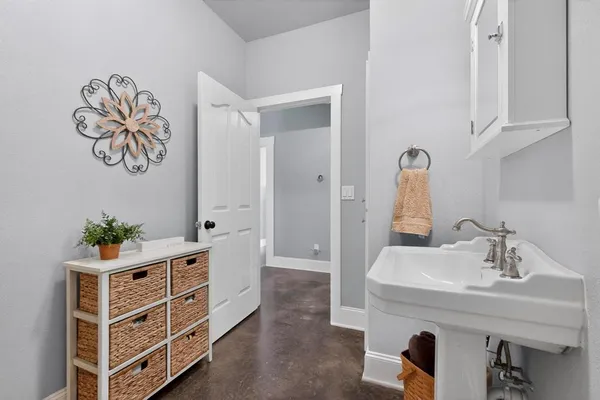 a spacious bedroom with a bed a couch and a window