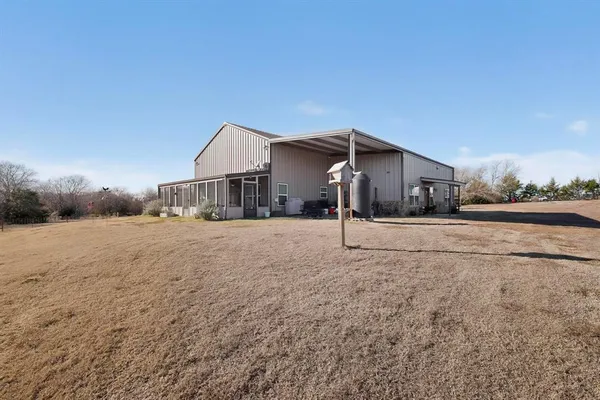 a view of a house with a backyard