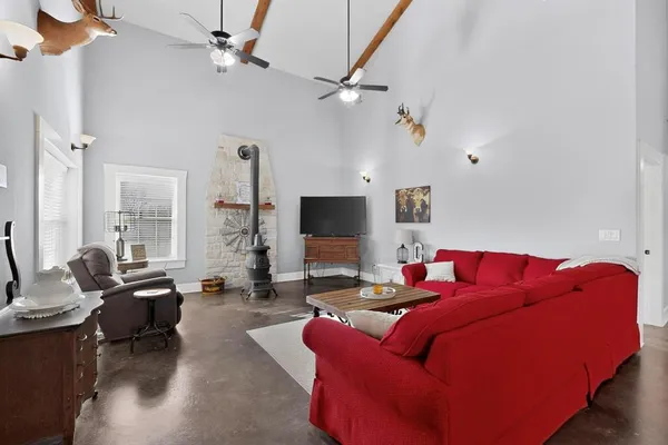 a living room with furniture kitchen view and a couch