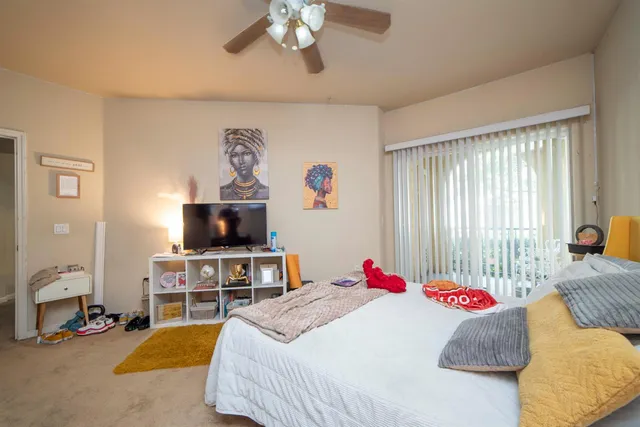 a bedroom with a bed and a flat screen tv