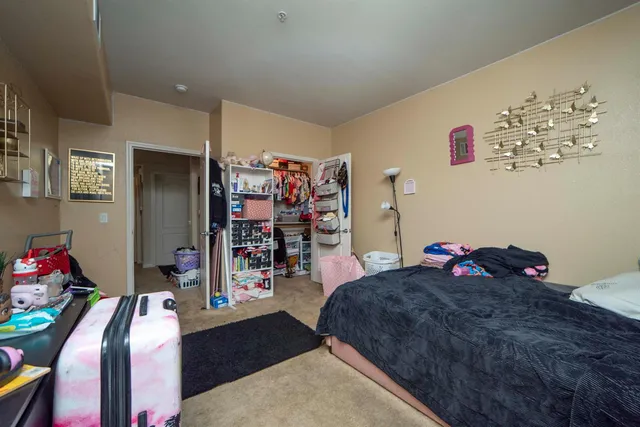 a bedroom with a bed and cabinets