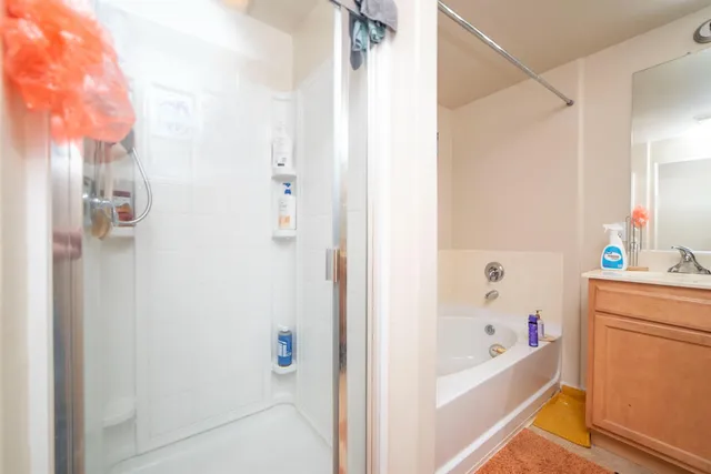 a bathroom with a bathtub a sink and a shower