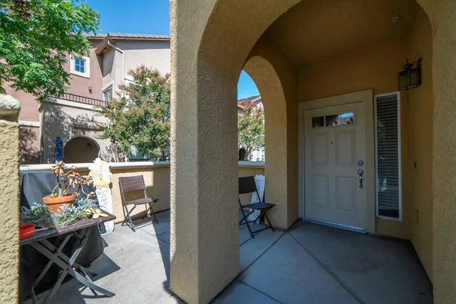 a view of a porch with furniture and front door