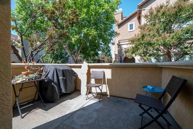 a balcony with table and chairs